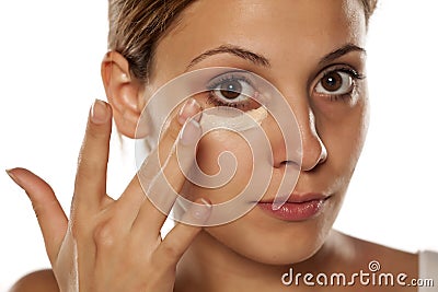 Concealer under her eyes Stock Photo