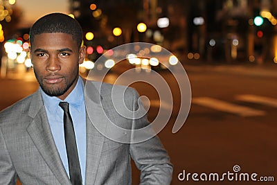 Conceited elegant businessman walking the streets at night with copy space Stock Photo