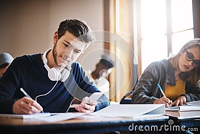 Concentrated on acing this exam. university students in class. Stock Photo