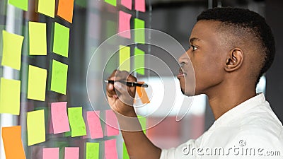 Concentrated african american male employee managing working tasks. Stock Photo