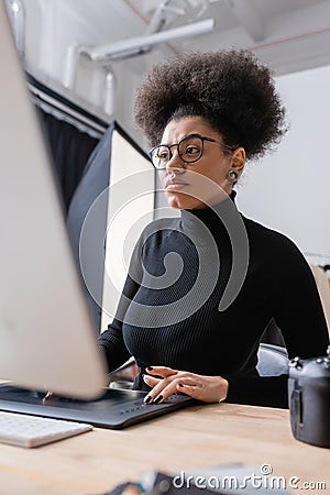 concentrated african american retoucher in black Stock Photo
