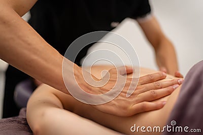 Concentrated Back Massage by Professional Masseuse Stock Photo