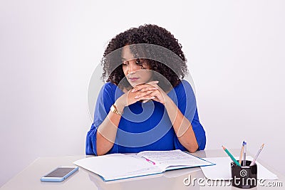 Concentrated beautiful young woman reading work material Stock Photo