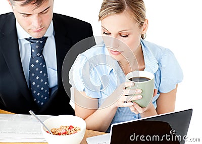 Concentrated couple of businesspeople reading news Stock Photo