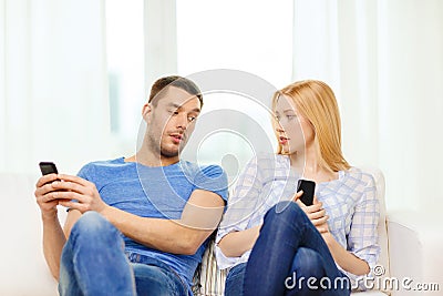 Concentrated couple with smartphones at home Stock Photo