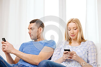 Concentrated couple with smartphones at home Stock Photo