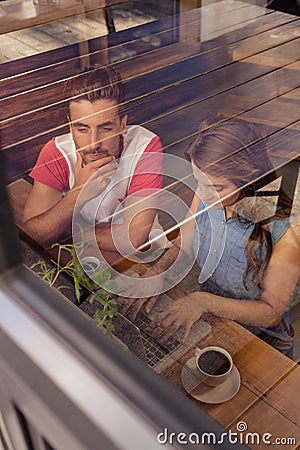 Concentrated couple using a laptop Stock Photo