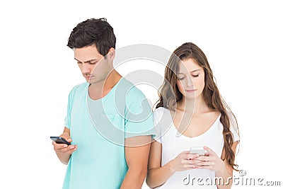 Concentrated couple using their smartphones Stock Photo