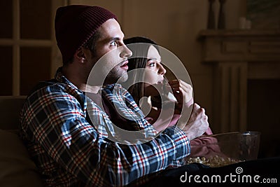 Concentrated couple watching movie at home Stock Photo