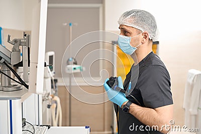 Concentrated doctor performing endoscopic ultrasound in procedure room Stock Photo