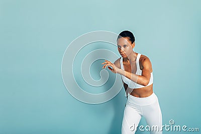 Concentrated female runner preparing for sprinting Stock Photo