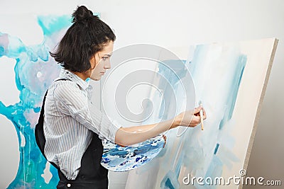 Concentrated girl focused on creative art-making process in art therapy Stock Photo