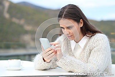 Concentrated girl uses phone in a coffee shop Stock Photo