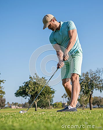 concentrated golfer in cap with golf club, golfing Stock Photo