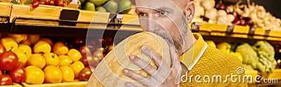 concentrated gray bearded male customer sniffing Stock Photo