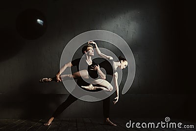 Concentrated gymnasts performing in interaction with each other Stock Photo