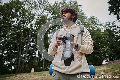 concentrated indian man holding digital camera Stock Photo