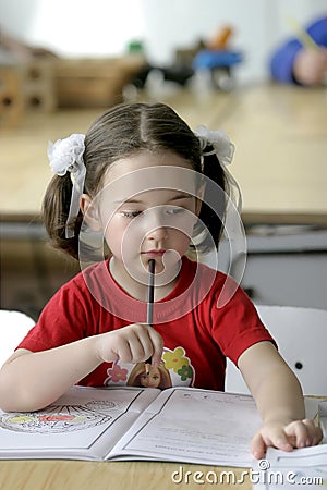 A concentrated little girl Stock Photo