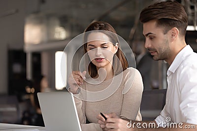 Concentrated male and female colleagues cooperating in office Stock Photo