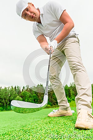 Concentrated male golfer with a golf club Stock Photo