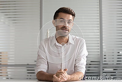 Concentrated male hr manager holding video distant job interview. Stock Photo