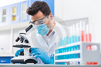 Concentrated male lab assistant discovering new data Stock Photo