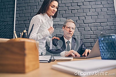 Positive delighted young assistant supporting her boss Stock Photo