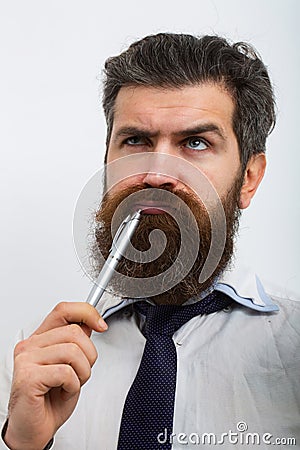 Concentrated man with pen in his mouth. He is thinking. Business concept. Escape from crisis. Funny face. Great Idea. Stock Photo