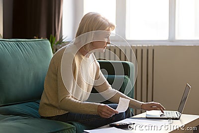 Contemporary elderly woman pay bills online on laptop Stock Photo