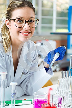 Concentrated scientist making experiment in laboratory. Stock Photo