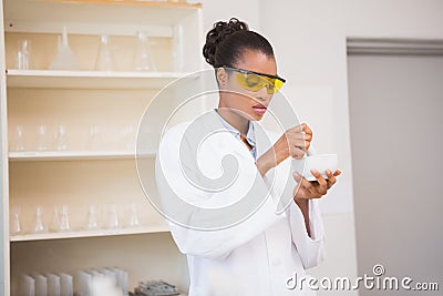 Concentrated scientist using pestle and mortar Stock Photo
