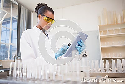 Concentrated scientist working with tablet Stock Photo