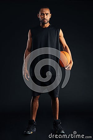 Concentrated serious african sports man holding basket ball Stock Photo