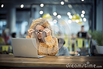 Concentrated and stressed caucasian adult woman at work on a laptop connected computer - airport gate waiting for the flight or Stock Photo