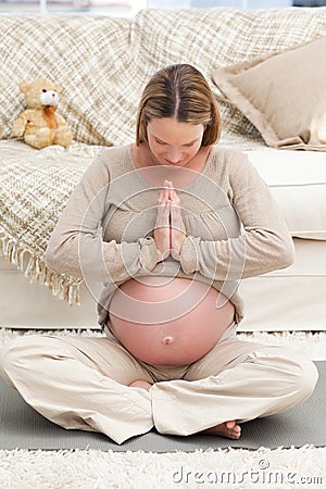 Concentrated woman doing yoga on the floor Stock Photo