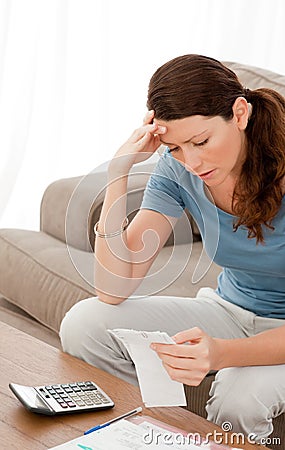 Concentrated woman looking at her bills Stock Photo