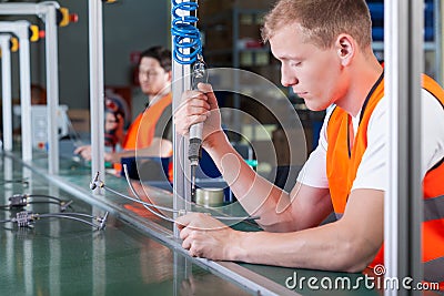 Concentrated workers on production line Stock Photo