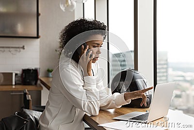 Concentrated young african american businesswoman multitasking in office. Stock Photo