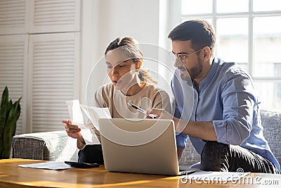 Focused young couple manage finances paying bills online Stock Photo