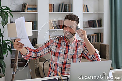 Concentrated young freelancer businessman using laptop for video conferance, working remotely online at home Stock Photo