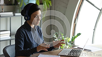 Concentrated young indian businesswoman holding video conference call with partners. Stock Photo