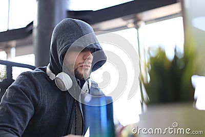 Concentrated young man in casual clothing using computer, streaming playthrough or walkthrough video Stock Photo