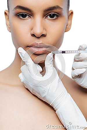 Concentrated young Negroid woman having the injection Stock Photo