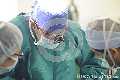 Concentrating surgeons performing operation Editorial Stock Photo