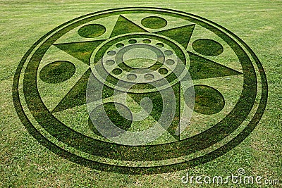 Concentric circles star fake crop circle in the meadow Stock Photo