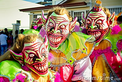 Closeup three men in scary clowns costumes pose for photo at dominican carnival Editorial Stock Photo