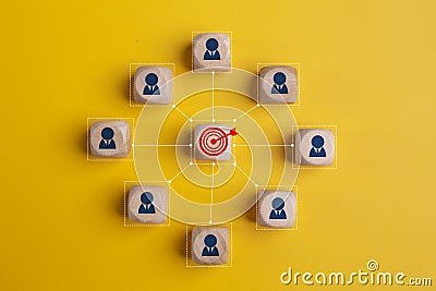 Concept of achieving goals by cooperating with team members with a human icon for customer focus target group and customer Stock Photo