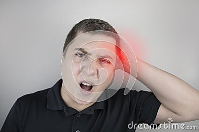 A man suffers from pain in the back of his head. Signs of cervical osteochondrosis, spondylosis, myositis, or hypertension. The Stock Photo