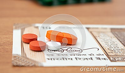 Concept of the affordable medicine in India due to generic drugs on Indian currency notes as background. Stock Photo
