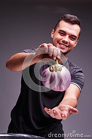 Big beautiful eggplant in man`s hands. Healthy lifestyle. Stock Photo